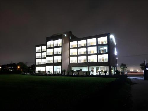 a large building at night with its lights on at Sea View Hotel in Jeju