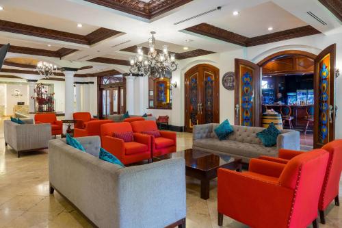 a lobby with couches and chairs and a chandelier at Clarion Hotel Real Tegucigalpa in Tegucigalpa