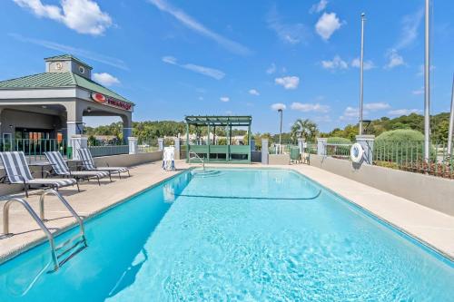 a pool at a resort with chairs and a gazebo at Econo Lodge in Goose Creek