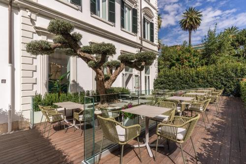 a patio with tables and chairs next to a building at The Spotlight Boutique Hotel in Rome