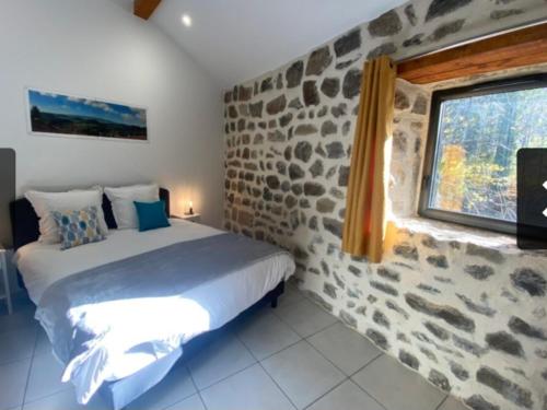 Postel nebo postele na pokoji v ubytování Le Moulin des Puys
