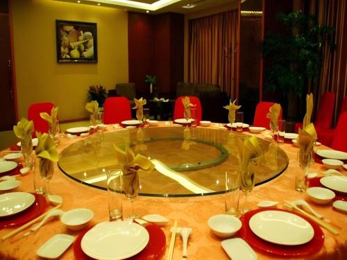a table with plates and glasses on top of it at Xiamen Airlines Quanzhou Hotel in Quanzhou