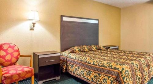 a hotel room with a bed and a chair at Rodeway Inn Mount Laurel Hwy 73 in Mount Laurel
