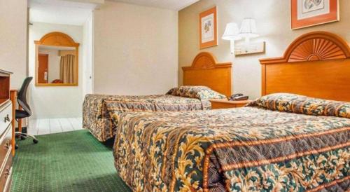 a hotel room with two beds in a room at Rodeway Inn Mount Laurel Hwy 73 in Mount Laurel