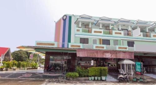 a large building with a store in front of it at OYO 75314 Mountain Beach in Prachuap Khiri Khan