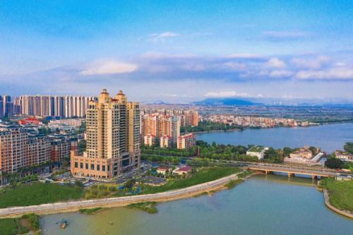 an aerial view of a city with a river and buildings at Hampton by Hilton Zhuhai Doumen in Zhuhai