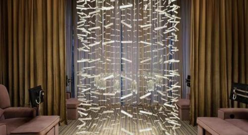 a large metal wall with white lights in a room at Putian Depo Hotel in Putian