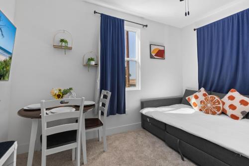 a small room with a bed and a table at Luxury 1BR Suite Bakersfield California in Bakersfield