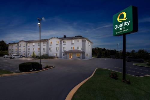 a hotel with a sign in front of a parking lot at Quality Inn in Johnstown