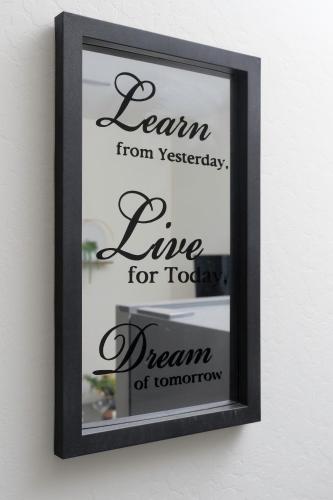 a black framed mirror hanging on a wall with the words learn from yesterday live for at Luxury 1BR Suite Bakersfield California in Bakersfield