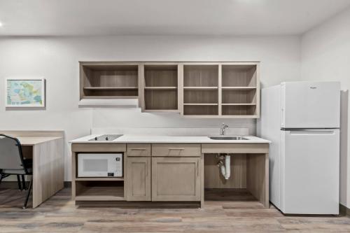 a kitchen with a sink and a refrigerator at WoodSpring Suites Tucson Medical Center in Tucson