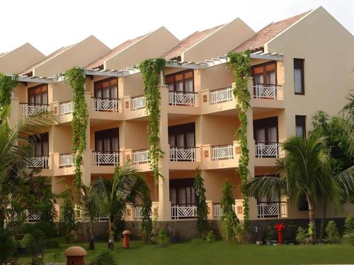 an exterior view of a building with plants at Can Gio Resort in Can Gio