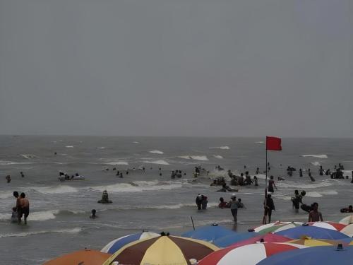 a group of people in the water at the beach at Can Gio Resort in Can Gio