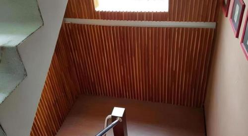 a room with a staircase with a wooden wall at Cactus Resort & Hotel in Khon Kaen