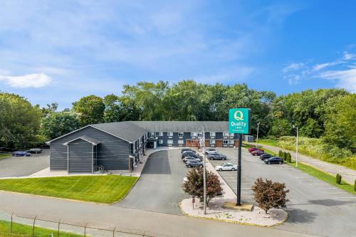 a building with a sign in front of a parking lot at Quality Inn in West Haven