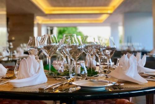 a table with wine glasses and napkins on it at Hodges Bay Resort & Spa, an HQ Luxury Resort & Residences in Saint Johnʼs