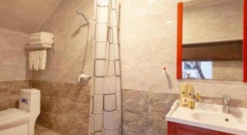 a bathroom with a shower and a toilet and a sink at Pingyao Yufengheng Hotel in Pingyao
