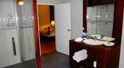 a bathroom with a sink and a shower and a mirror at Brook Boutique in Sigiriya