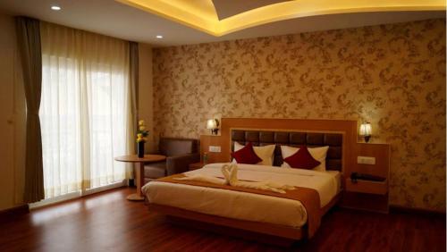 a bedroom with a large bed with red pillows at Staynest Continetal With parking Near Mg Marg in Gangtok