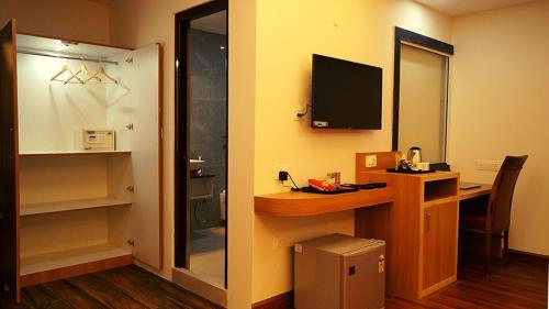 a room with a desk with a computer and a monitor at Staynest Continetal With parking Near Mg Marg in Gangtok