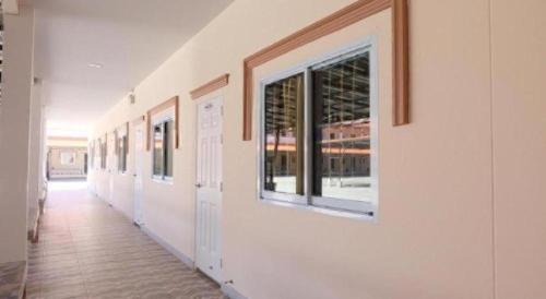 a hallway with a row of windows on a wall at The Phant Hotel in Surin