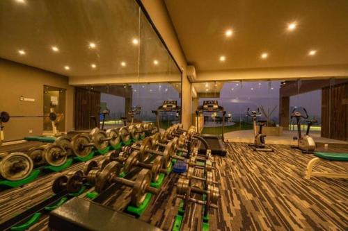 a gym with a bunch of dumbbells in a room at Hotel Castle Salam in Khulna