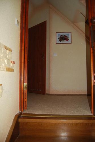 a hallway with a door in a room with a stair at Villa Europa in Mielno