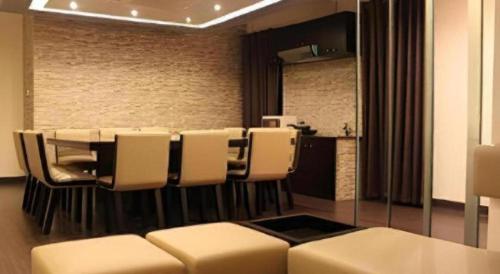 a conference room with a table and white chairs at Hotel Castle Salam in Khulna