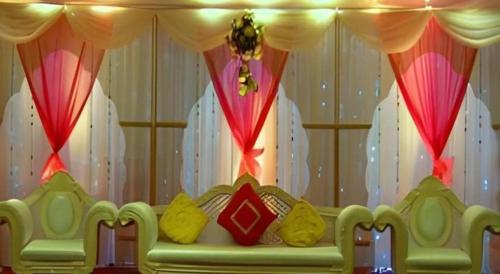 a room with a couch in front of a curtain at Hotel Castle Salam in Khulna