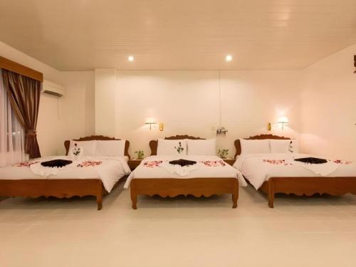 a bedroom with three beds in a room at Asia Hotel in Phnom Penh