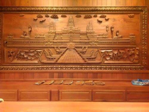 a wooden wall with a carving of a temple at Asia Hotel in Phnom Penh