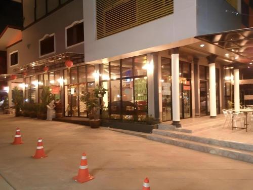 a group of orange cones in front of a building at Waenpetch place Hotel in Ubon Ratchathani