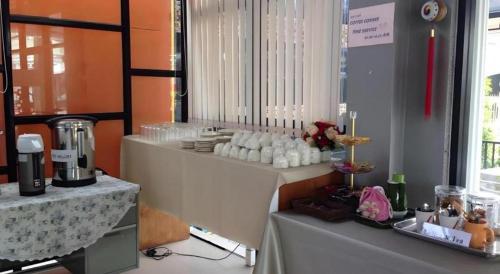 a room with a table with aasteryasteryasteryasteryasteryasteryasteryasteryastery at Waenpetch place Hotel in Ubon Ratchathani