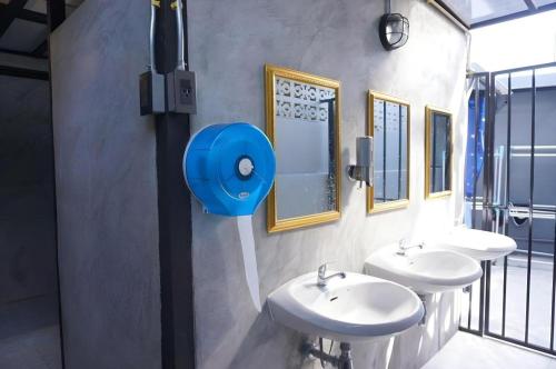 a bathroom with two sinks and two mirrors at Near beach hostel in Bang Tao Beach
