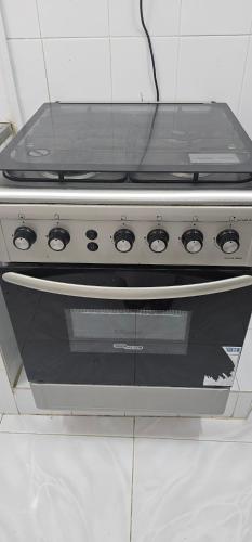 a stove top oven sitting in a kitchen at هومي in Salalah