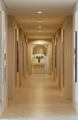 a hallway with a long hallway with a table with flowers at Double G Resort Anyer in Carita