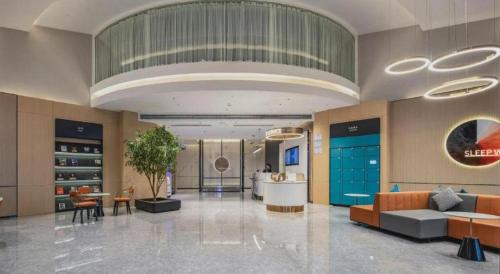 a lobby with couches and tables in a building at City Comfort Inn Nanning Guangxi University in Nanning