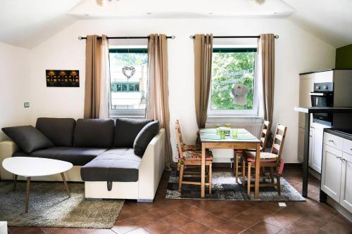 a living room with a couch and a table at Millenium Inn in Mürzzuschlag