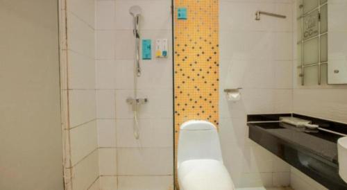 a bathroom with a shower with a toilet and a sink at City Comfort Inn Nanning Guangxi University in Nanning