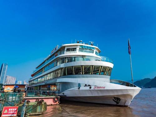 a large cruise ship is docked in the water at Lavande Hotels·Yichang Wanda Plaza in Yichang