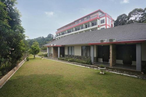 a building with a large yard in front of it at Fafa Hill Hotel and Resort in Bogor