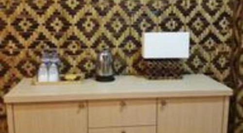 a counter with a blender on it with a wall at Fafa Hill Hotel and Resort in Bogor