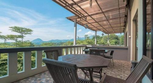 a patio with a table and chairs on a balcony at Fafa Hill Hotel and Resort in Bogor