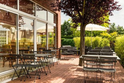 a row of tables and chairs outside of a restaurant at ibis Massy in Massy