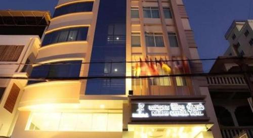 a tall building with a sign in front of it at Kirirom Crystal Hotel in Phnom Penh