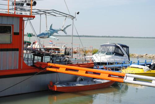 a boat with a shark on the side of it at Hotel Kormorán in Šamorín