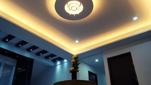 a room with a ceiling with a clock on it at Staynest Continetal With parking Near Mg Marg in Gangtok