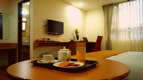a tray of food on a table in a hotel room at Staynest Continetal With parking Near Mg Marg in Gangtok