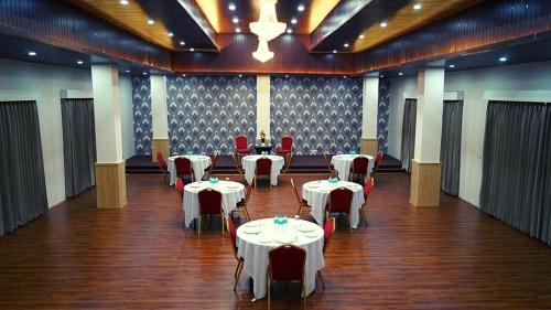 a large room with tables and chairs and a room with tables and chairs at Staynest Continetal With parking Near Mg Marg in Gangtok