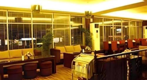 a lobby with couches and chairs in a building at Hotel Formosa in Manado